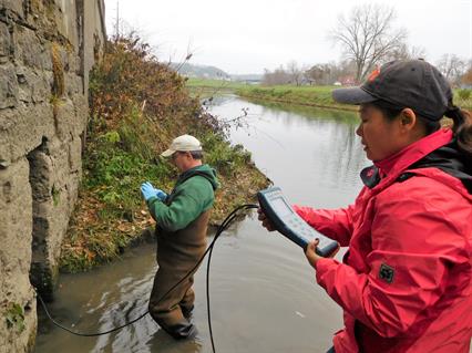 Kelly, Li Taking Water Quality Sample (Galena, 2017) Kelly and Li Taking a Water Quality Sample of a Spring Outlet in Galena, Illinois