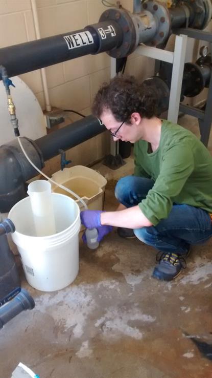 Devin Mannix Well Sample (2015) ISWS Employee Devin Mannix takes a well sample for water quality analysis, 2015
