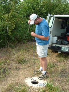 man measuring a well