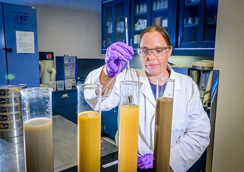 ISWS-Sediments-lab-240620-FZ-054 Kim pulling sediment from sample.